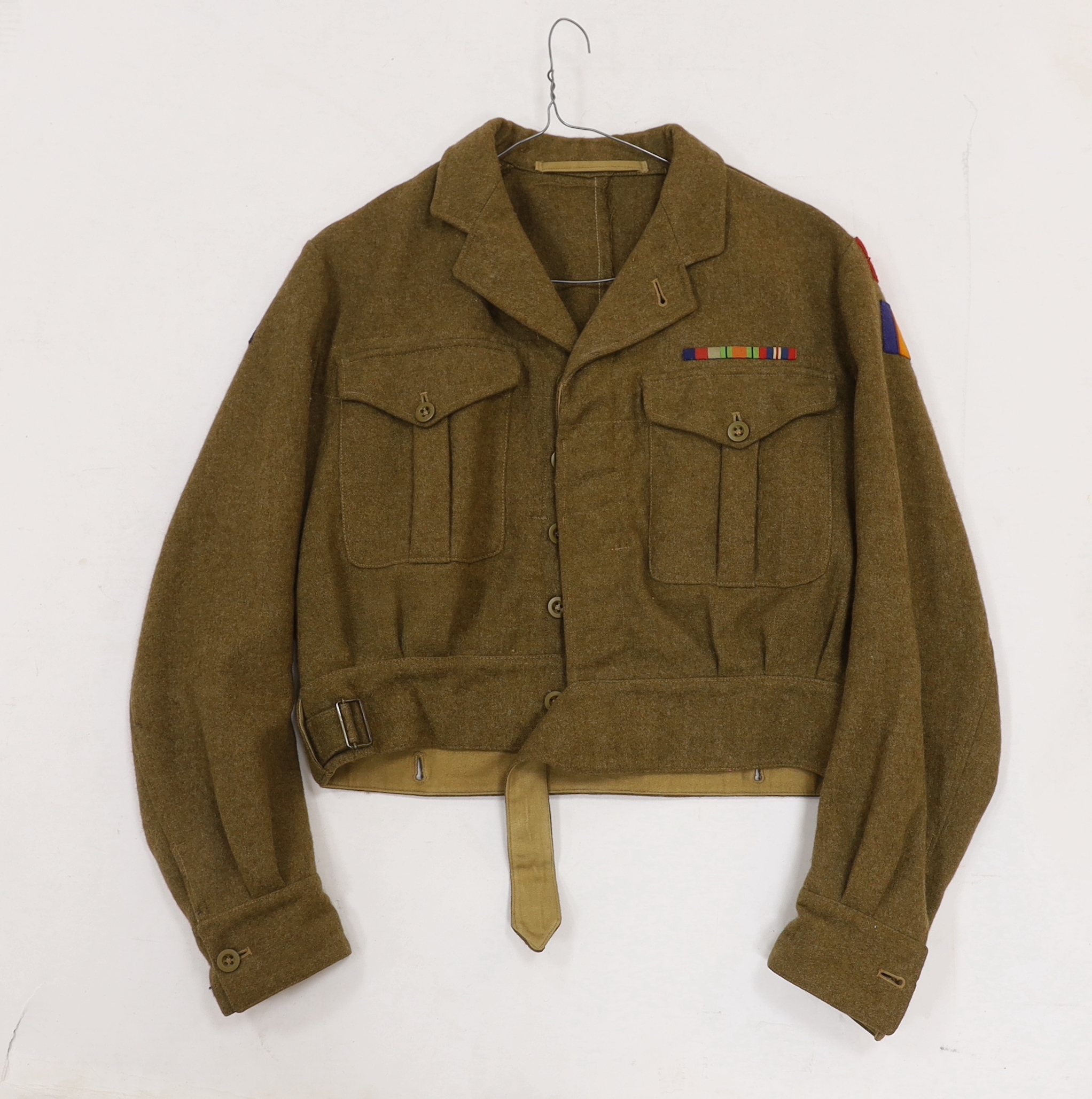 Eight British military uniform blouses/jackets, including two with Royal Sussex Regiment Cinque Ports shoulder insignia, a Queen’s A.C.F. example, etc.
